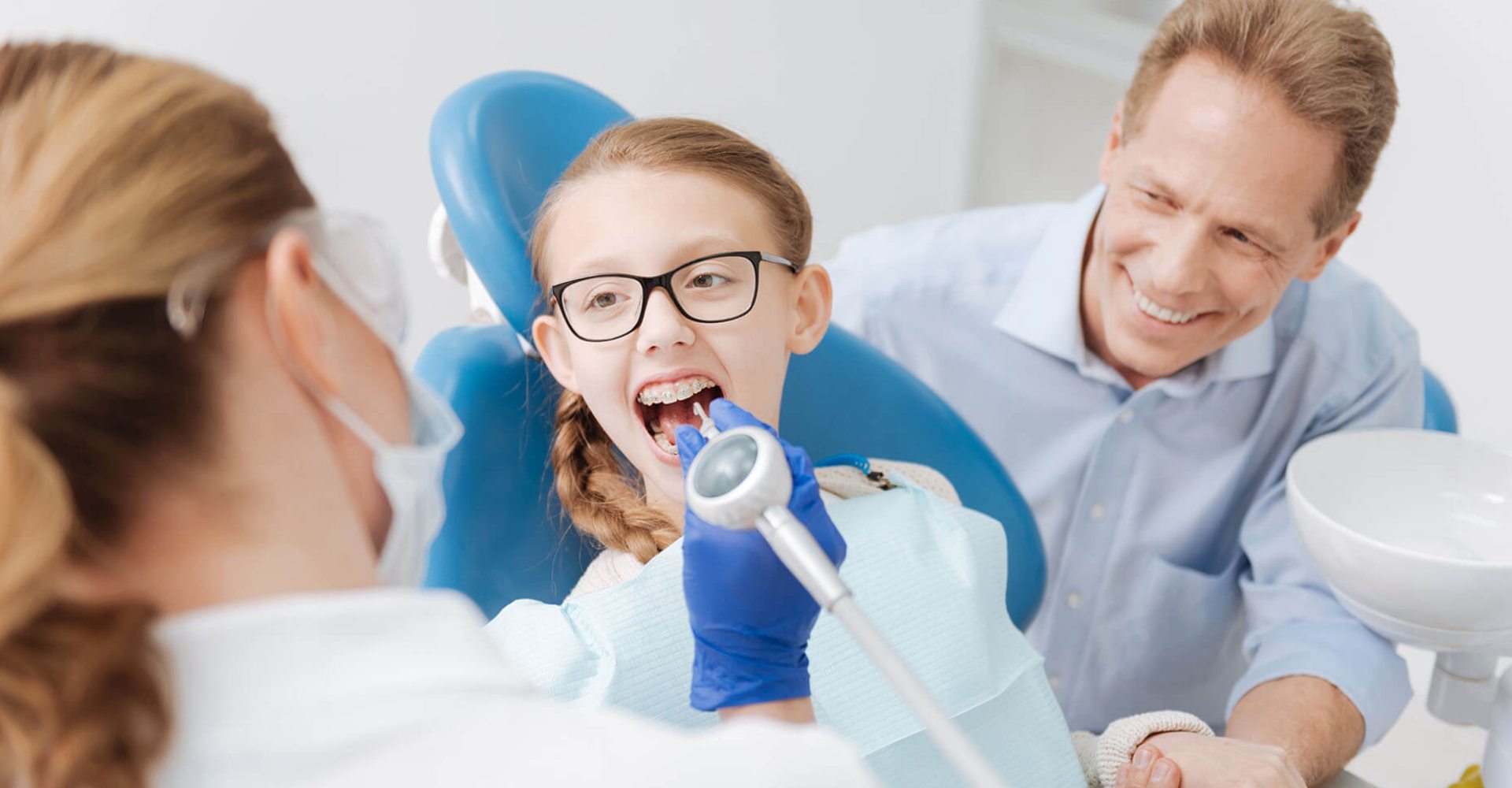 a woman in a blue shirt and a man in a blue shirt  at dental implants in Reston, VA