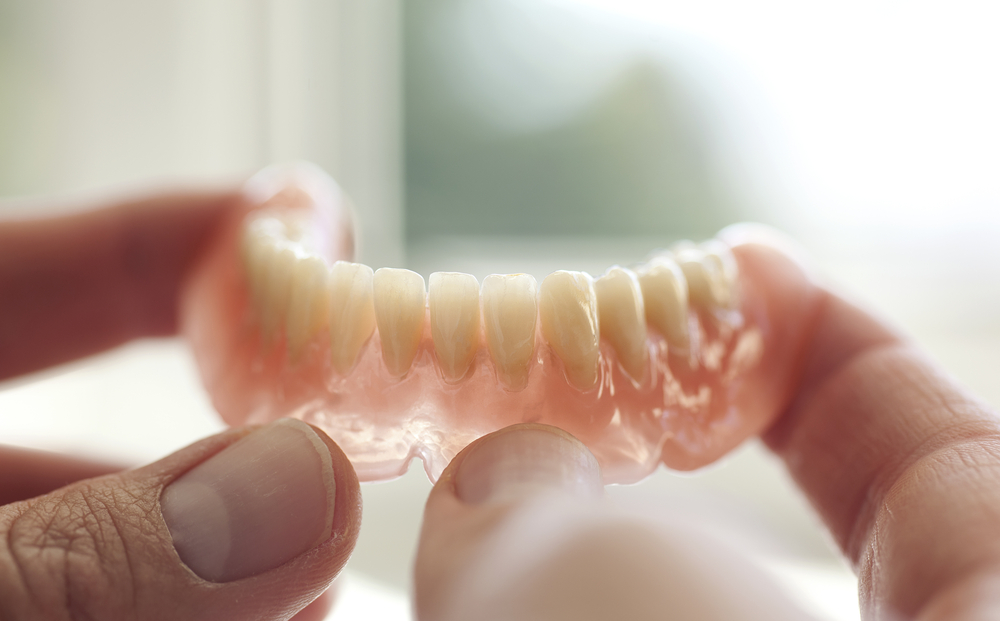 a person holding a piece of food in their hand  at teeth whitening Reston in Reston, VA