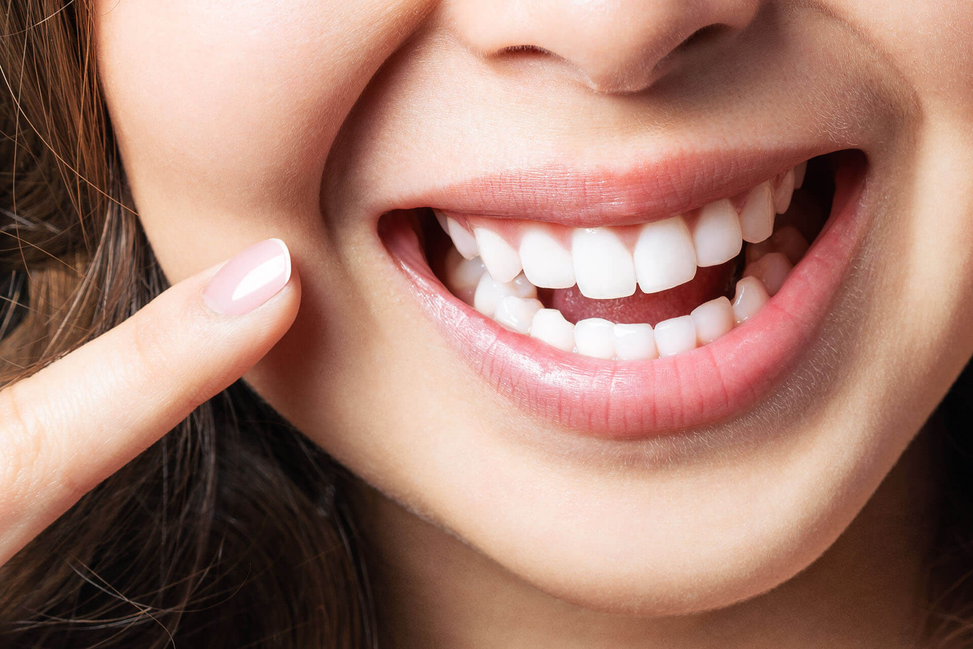 a woman with a red hair is smiling  at pediatric dentistry Reston in Reston, VA