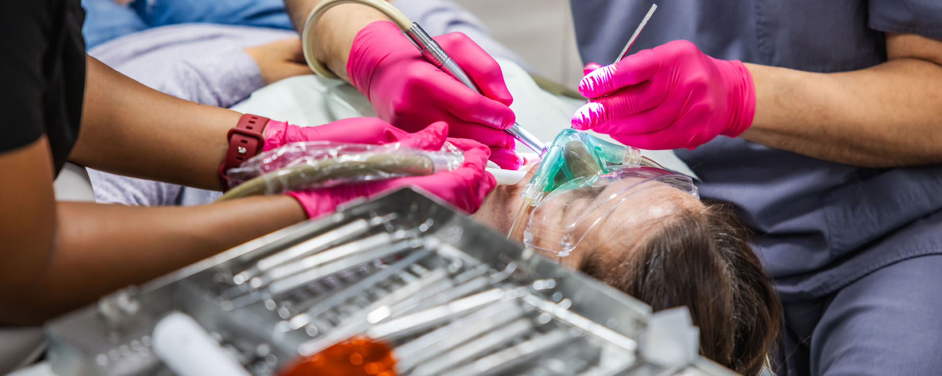 a woman cutting a woman's nails with scissors  at preventive dental care in Reston, VA