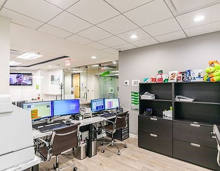 a desk with a computer and a laptop  at cosmetic dentistry in Reston, VA