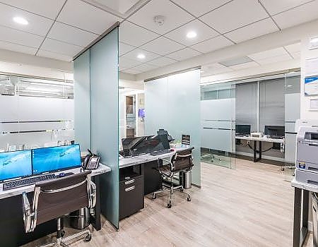 a large room with a desk and a laptop  at CEREC crowns in Reston, VA