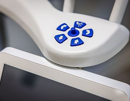 a remote control is attached to a white board  at dental implants in Reston, VA