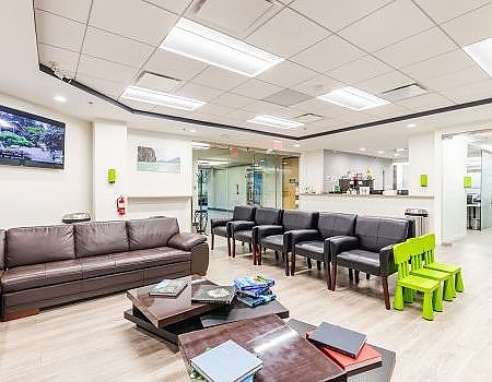 a living room filled with furniture and a large window  at dental services Reston in Reston, VA