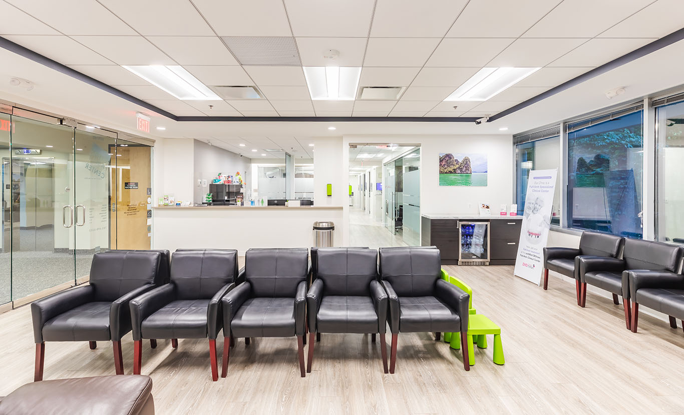 a living room with a couch, chairs, and a table  at family dentistry in Reston, VA