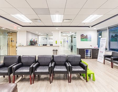 a living room with a couch, chairs, and a table  at family dentistry in Reston, VA