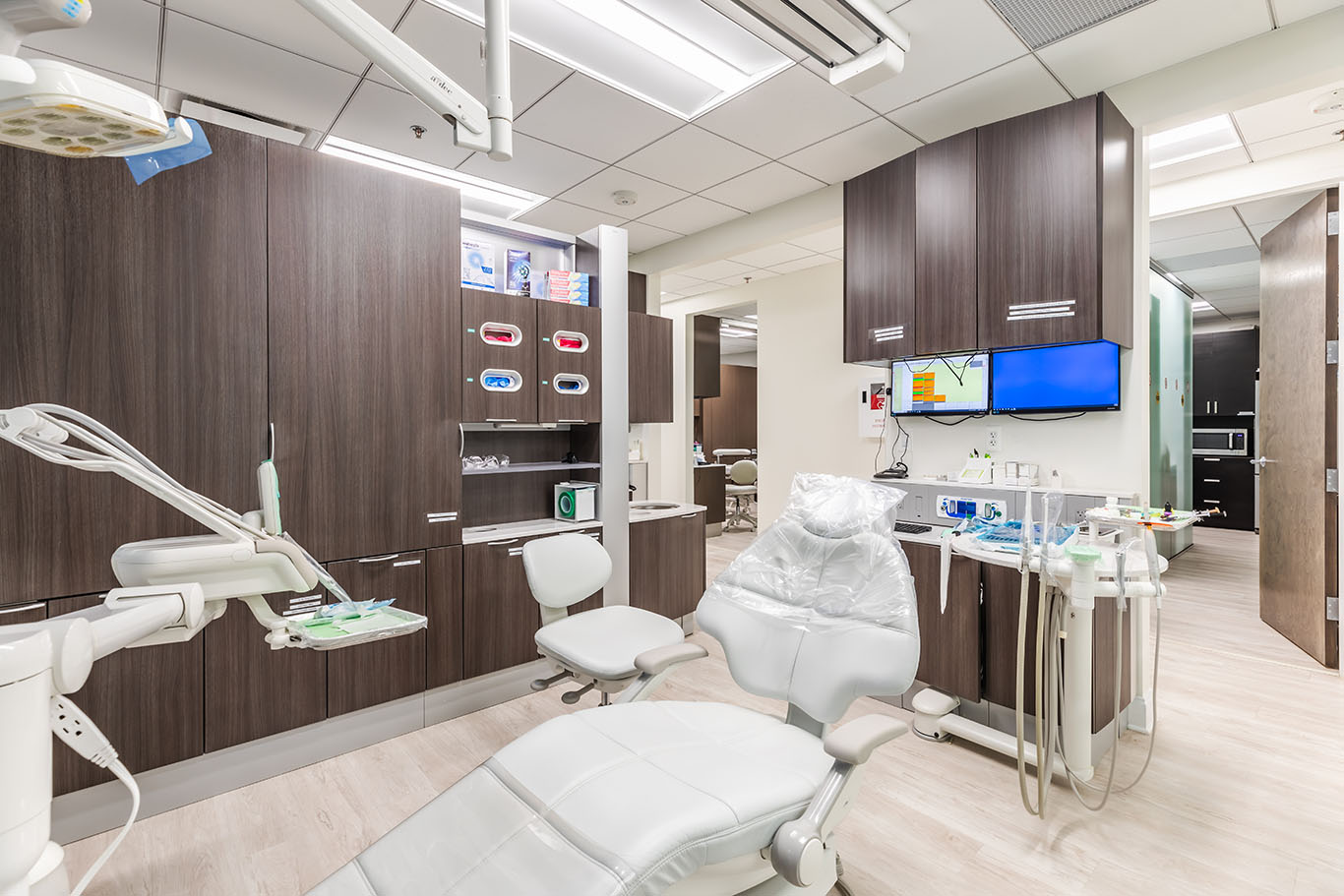 a room with a desk, chair, and a television  at preventive dental care in Reston, VA