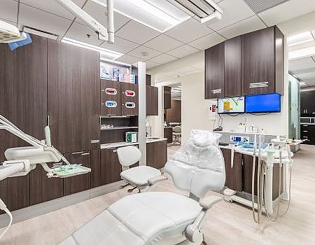 a room with a desk, chair, and a television  at preventive dental care in Reston, VA