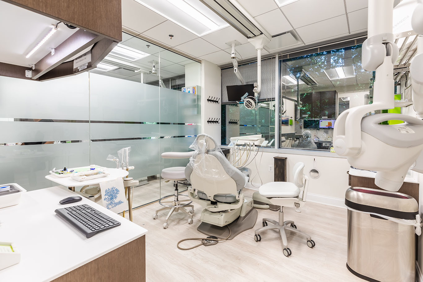 a room with a desk, chairs, and a computer  at family dentistry in Reston, VA