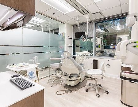 a room with a desk, chairs, and a computer  at family dentistry in Reston, VA