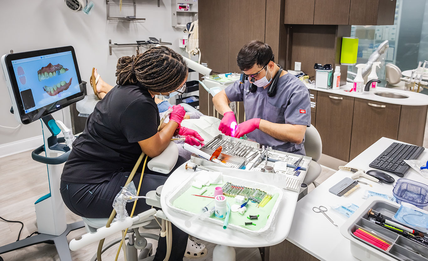 a man and woman working on a computer  at family dentistry in Reston, VA