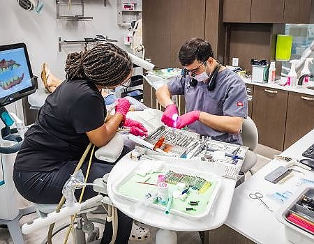 a man and woman working on a computer  at family dentistry in Reston, VA