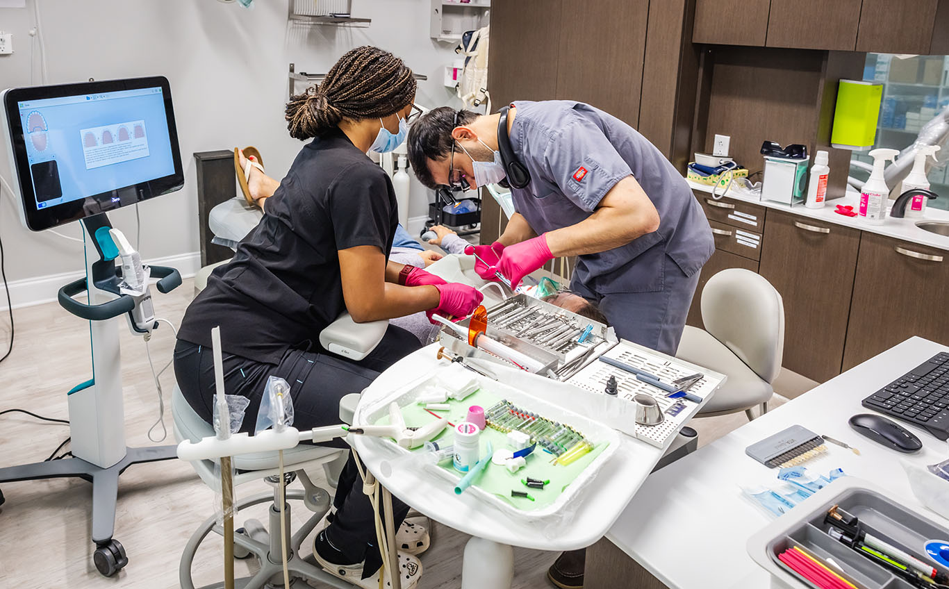 a man and a woman working on a computer  at dental services Reston in Reston, VA