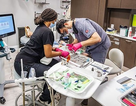 a man and a woman working on a computer  at dental services Reston in Reston, VA